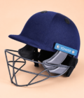 01-hero Navy YONKER cricket helmet front three-quarter view on pastel apricot background