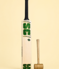 Wonder cricket bat craftsmanship view with wooden mallet on pastel yellow background
